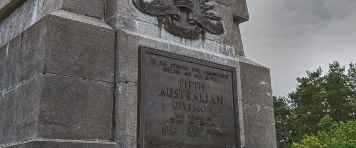A monument with inscriptions and a flag.