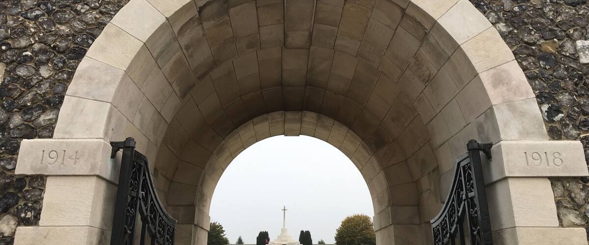 Una entrada arqueada a un cementerio con la inscripción "Lynn Cot Cemetery" y las fechas "1914" y "1918" en el arco.