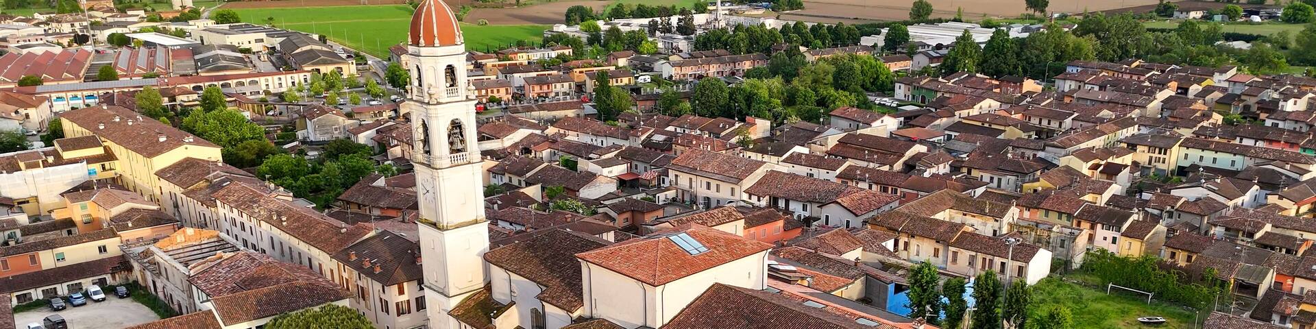 Pontevico Italy aerial views showcasing historic church bell tower and tiled rooftops a picturesque Italian townscape