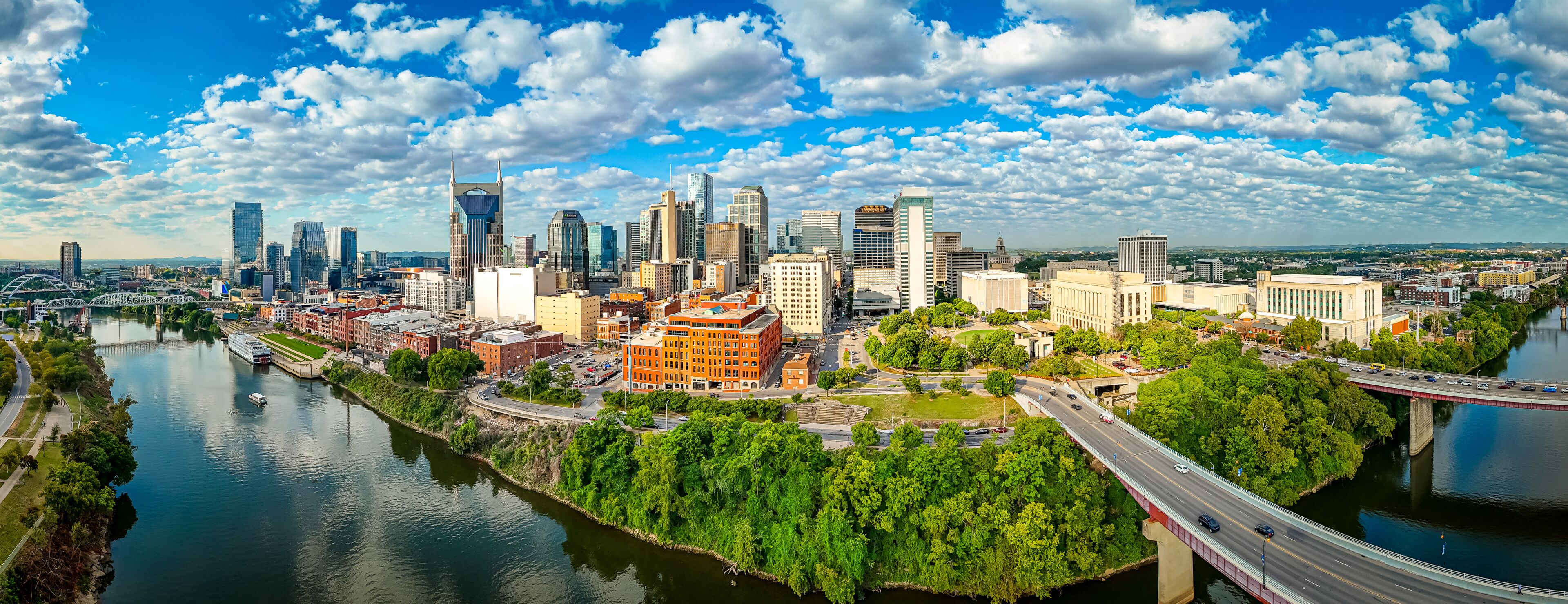 Nashville skyline at sunrise with river and modern skyscrapers