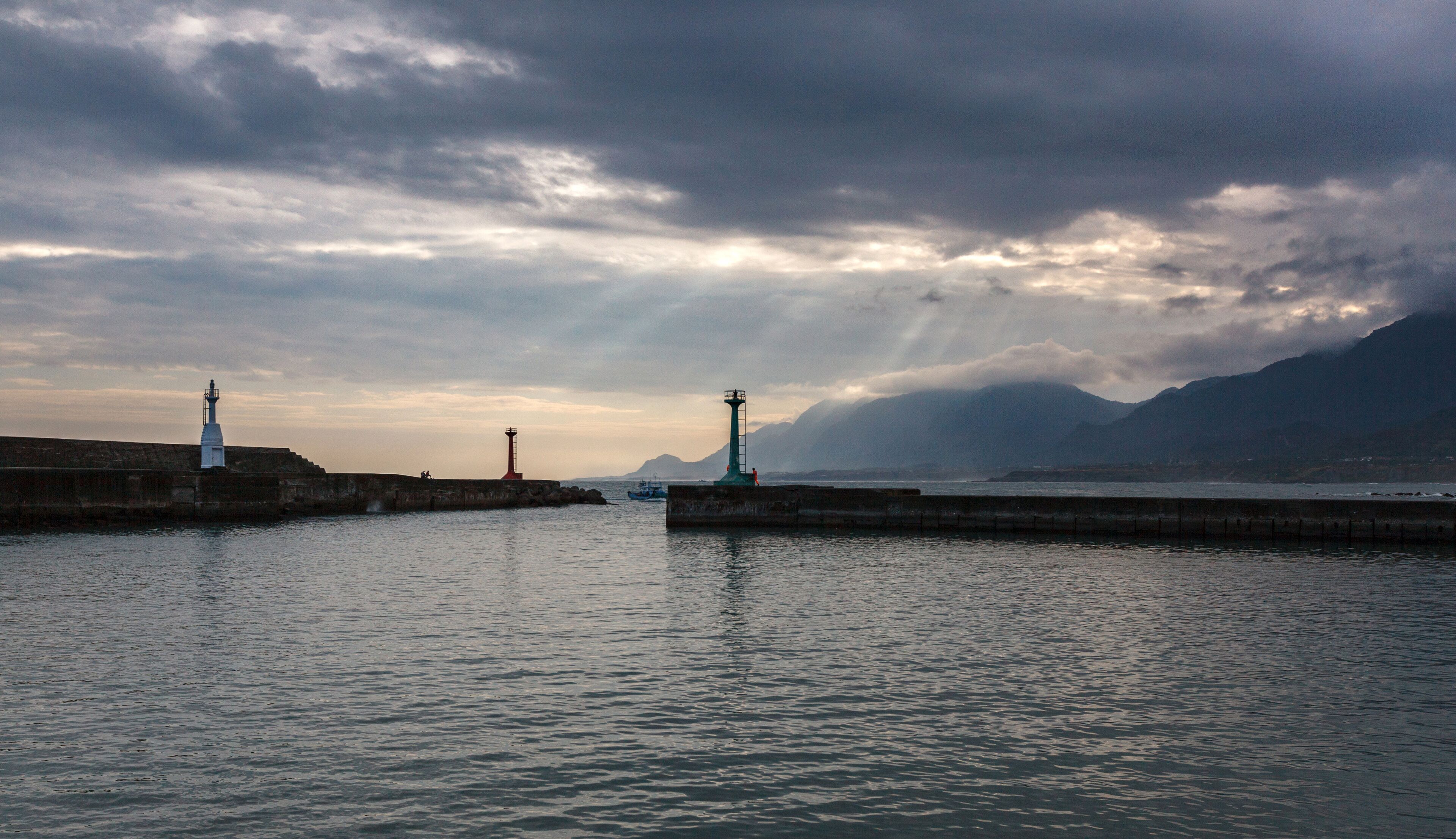 Peaceful Harbour, mountain island background with sunset and rays of sunlight streaming between the clouds - Chenggong Harbour, Taiwan
