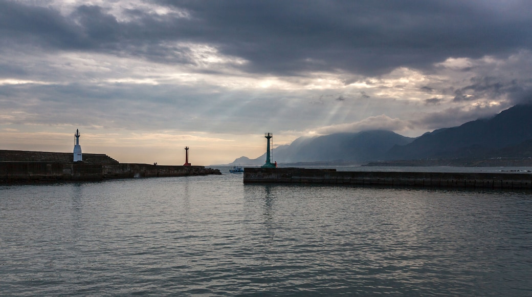 Peaceful Harbour, mountain island background with sunset and rays of sunlight streaming between the clouds - Chenggong Harbour, Taiwan