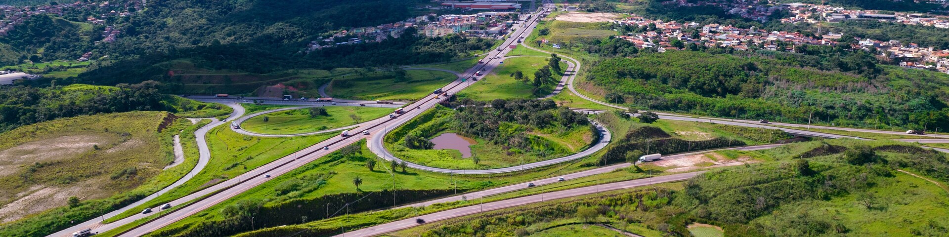 A highway interchange with multiple lanes and a city in the background.