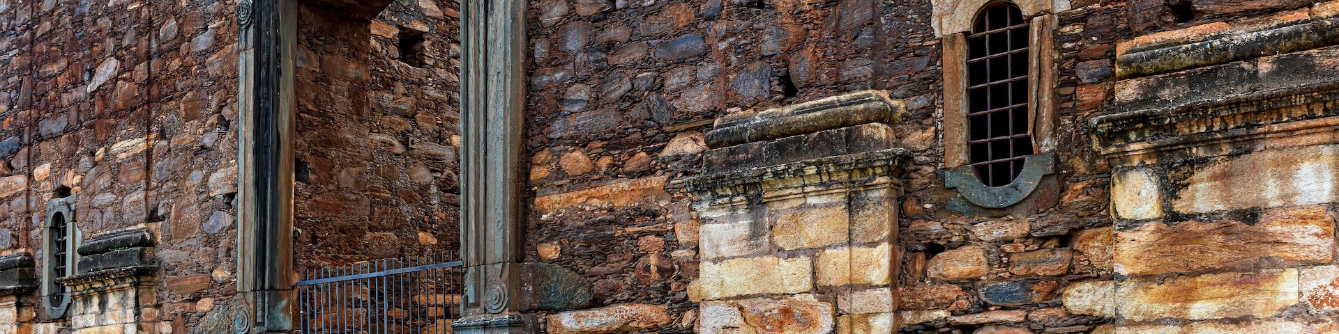 Strong stone walls of unfinished historic colonial church in ruins in the city of Sabara in Minas Gerais, Brazil