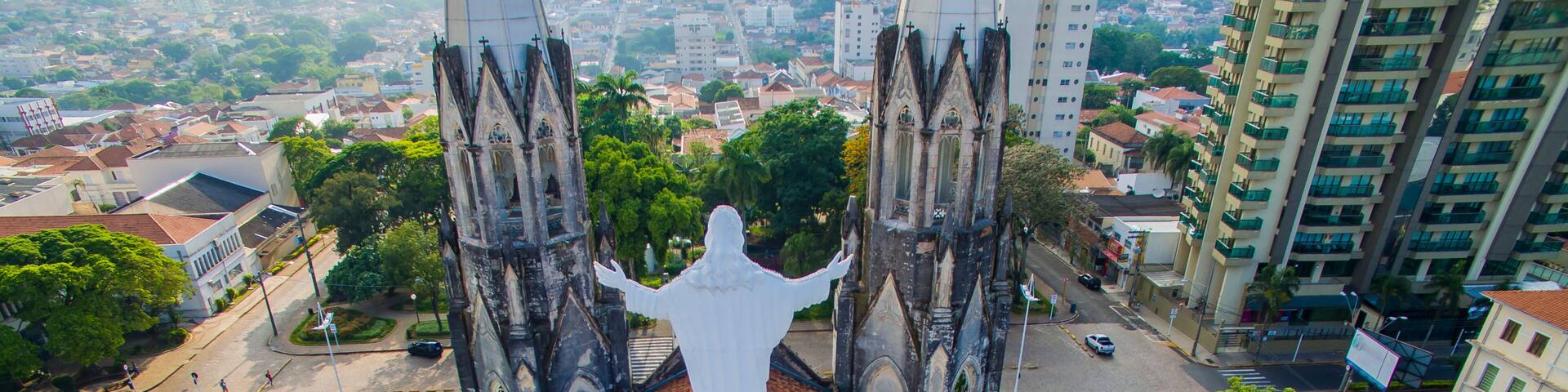 Statue of Jesus Christ on top of the Catholic Church, Cathedral of Sant'Ana, City of Botucatu, Sao Paulo State Brazil South America. Metropolitan Cathedral of Botucatu has Gothic style.