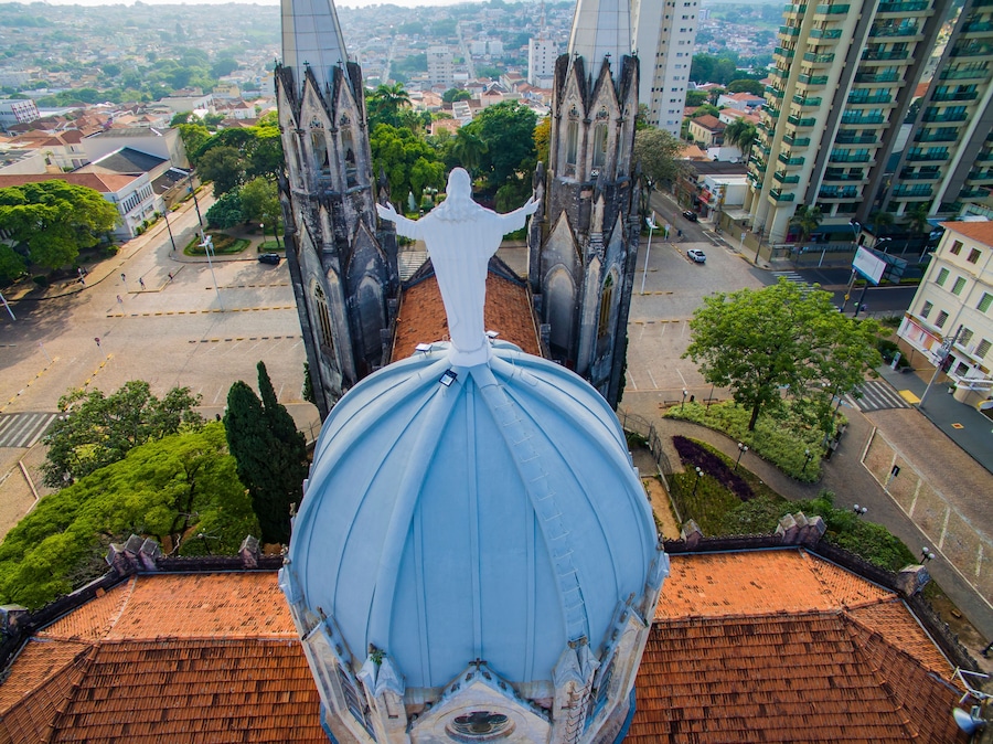 Statue of Jesus Christ on top of the Catholic Church, Cathedral of Sant'Ana, City of Botucatu, Sao Paulo State Brazil South America. Metropolitan Cathedral of Botucatu has Gothic style.