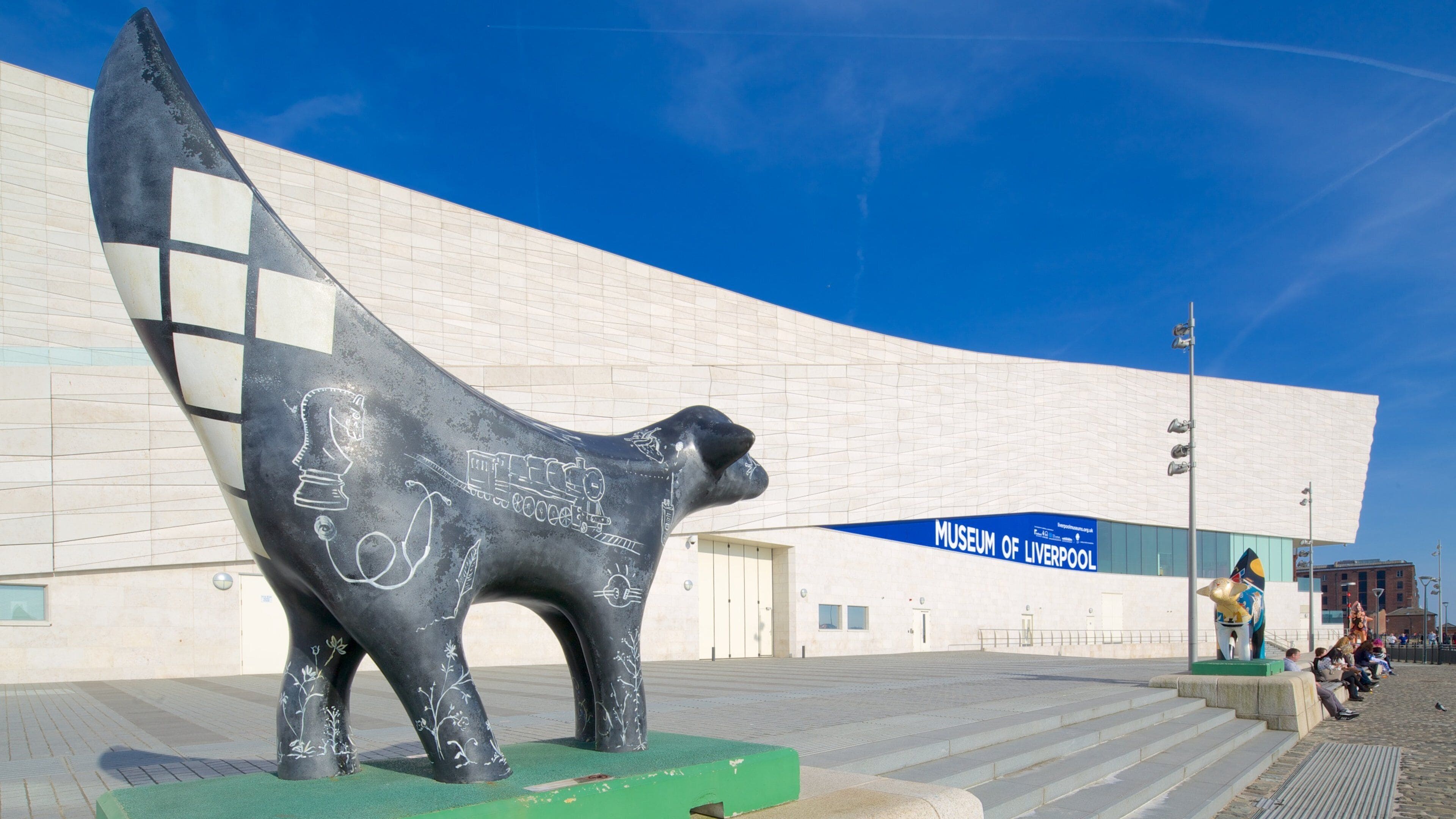 A sculpture of a dog in front of the Museum of Liverpool.