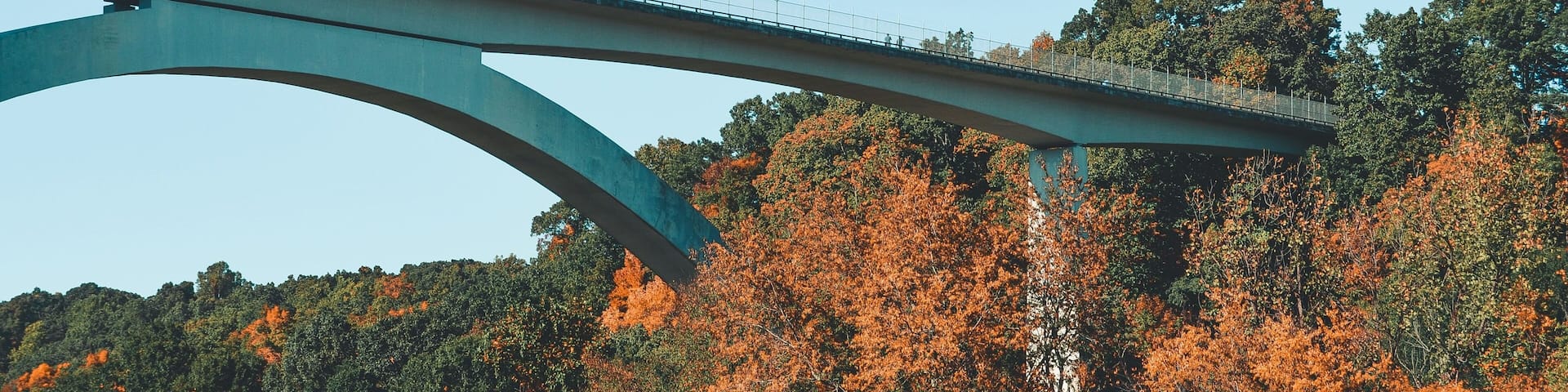Double arch bridge over colorful trees around in Tennessee under sunset sky