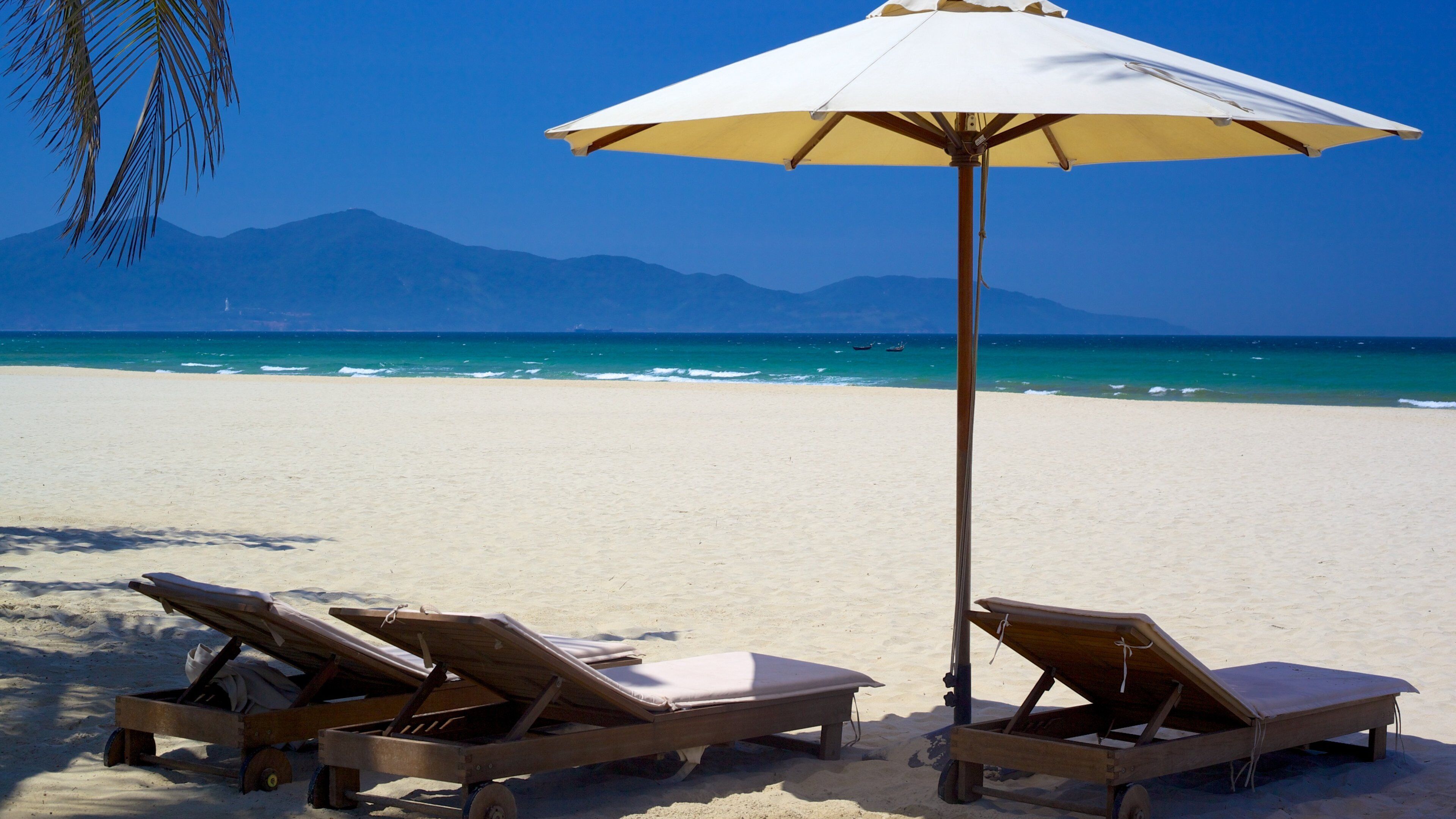 Non Nuoc Beach which includes tropical scenes, a sandy beach and a luxury hotel or resort