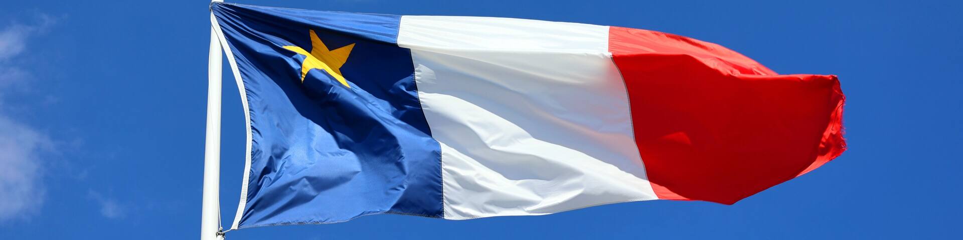 The flag of Acadia was adopted on 15 August 1884, at the Second Acadian National Convention held in Miscouche, Prince Edward Island, by nearly 5,000 Acadian delegates from across the Maritimes.