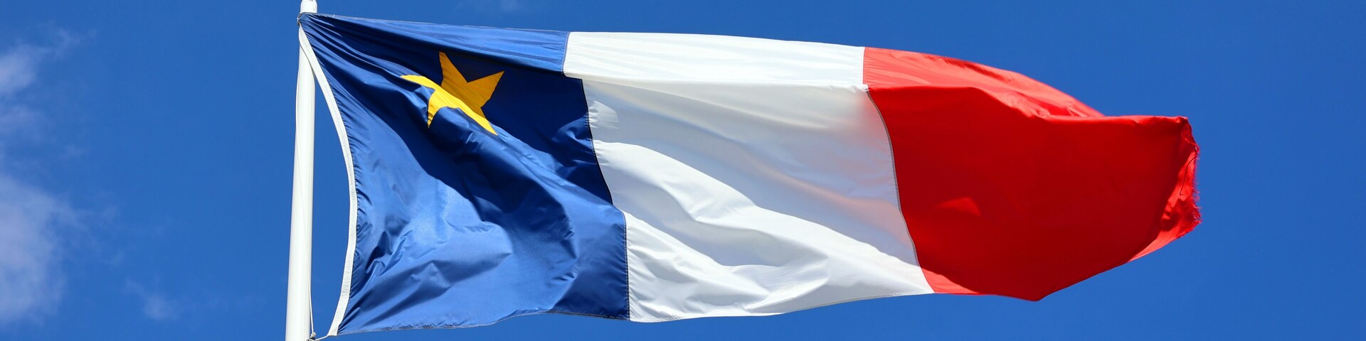 The flag of Acadia was adopted on 15 August 1884, at the Second Acadian National Convention held in Miscouche, Prince Edward Island, by nearly 5,000 Acadian delegates from across the Maritimes.