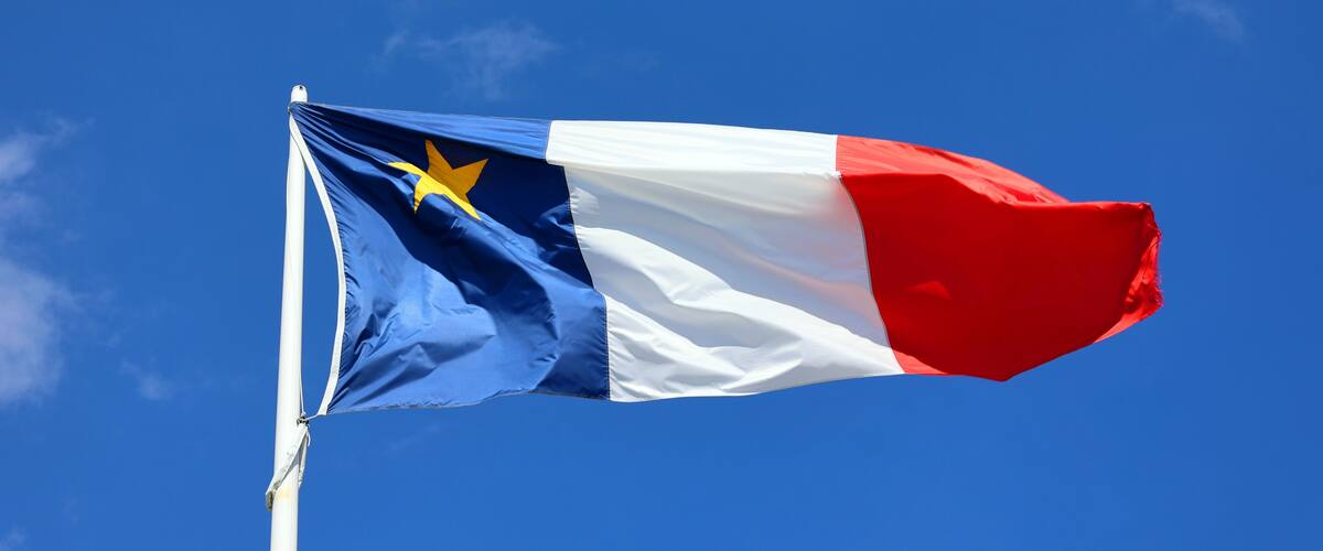 A flag with a blue field, a white stripe, and a red field with a yellow star.