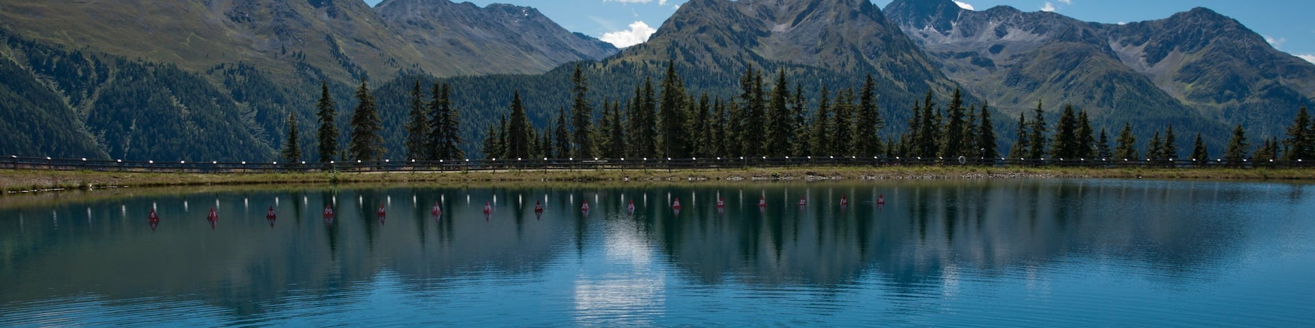 Kappl showing a lake or waterhole as well as a small group of people