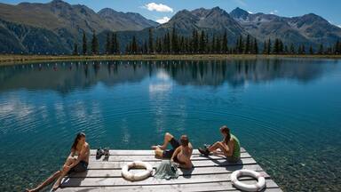Kappl showing a lake or waterhole as well as a small group of people