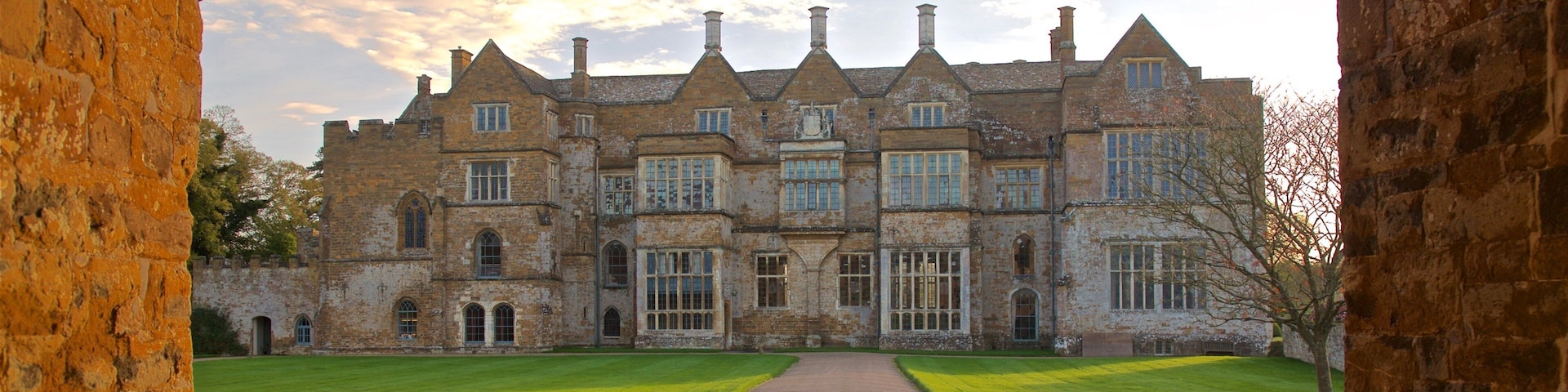 Broughton Castle featuring heritage architecture and a sunset