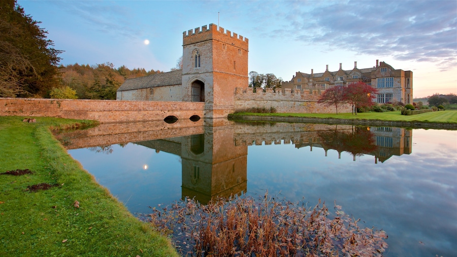 Broughton Castle featuring a sunset, a lake or waterhole and heritage architecture