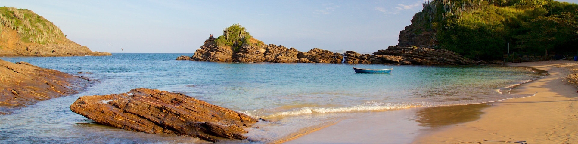 Ferradurinha Beach which includes rugged coastline, a sandy beach and a sunset