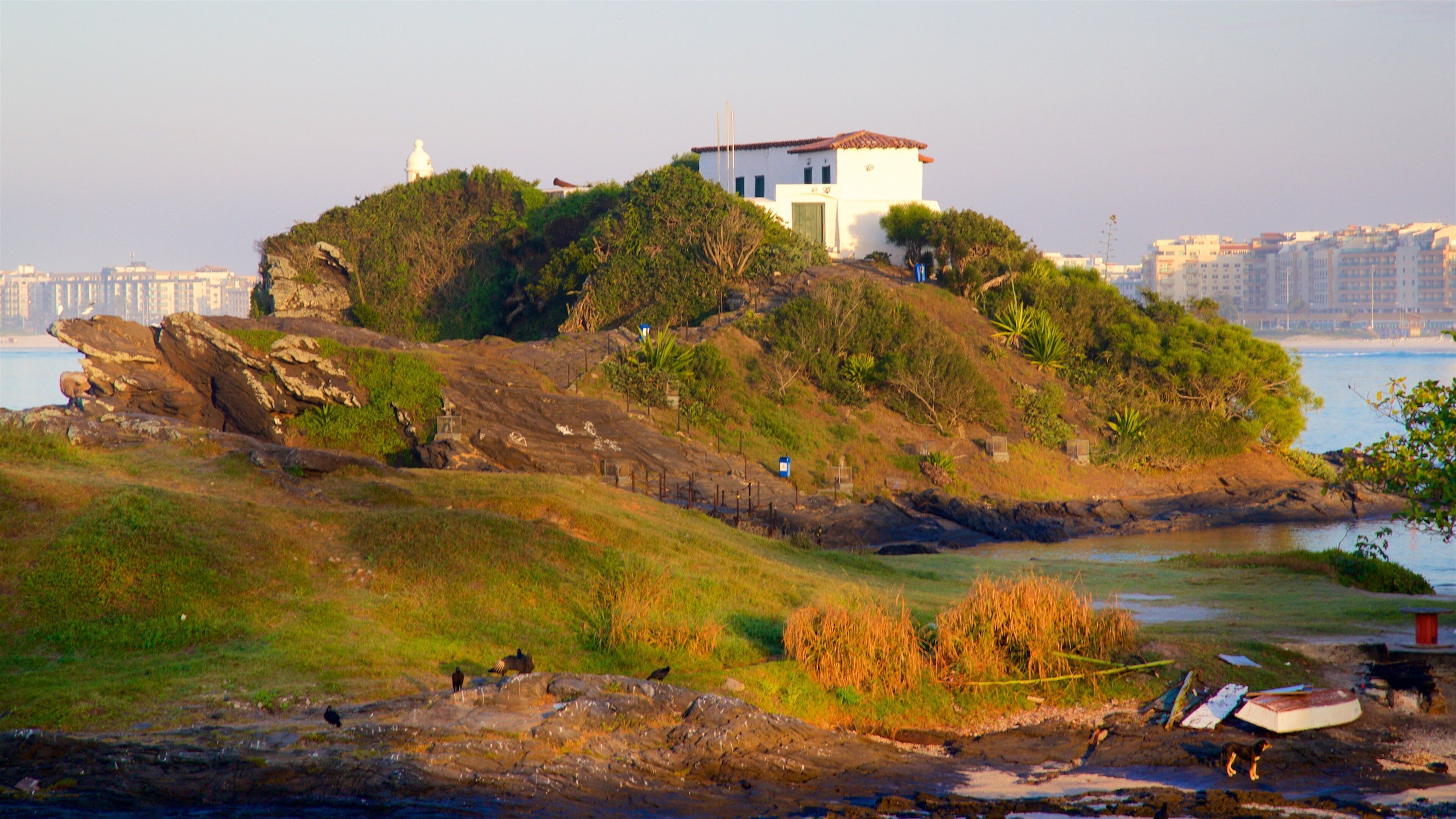 Sao Mateus Fort showing a coastal town, a sunset and general coastal views