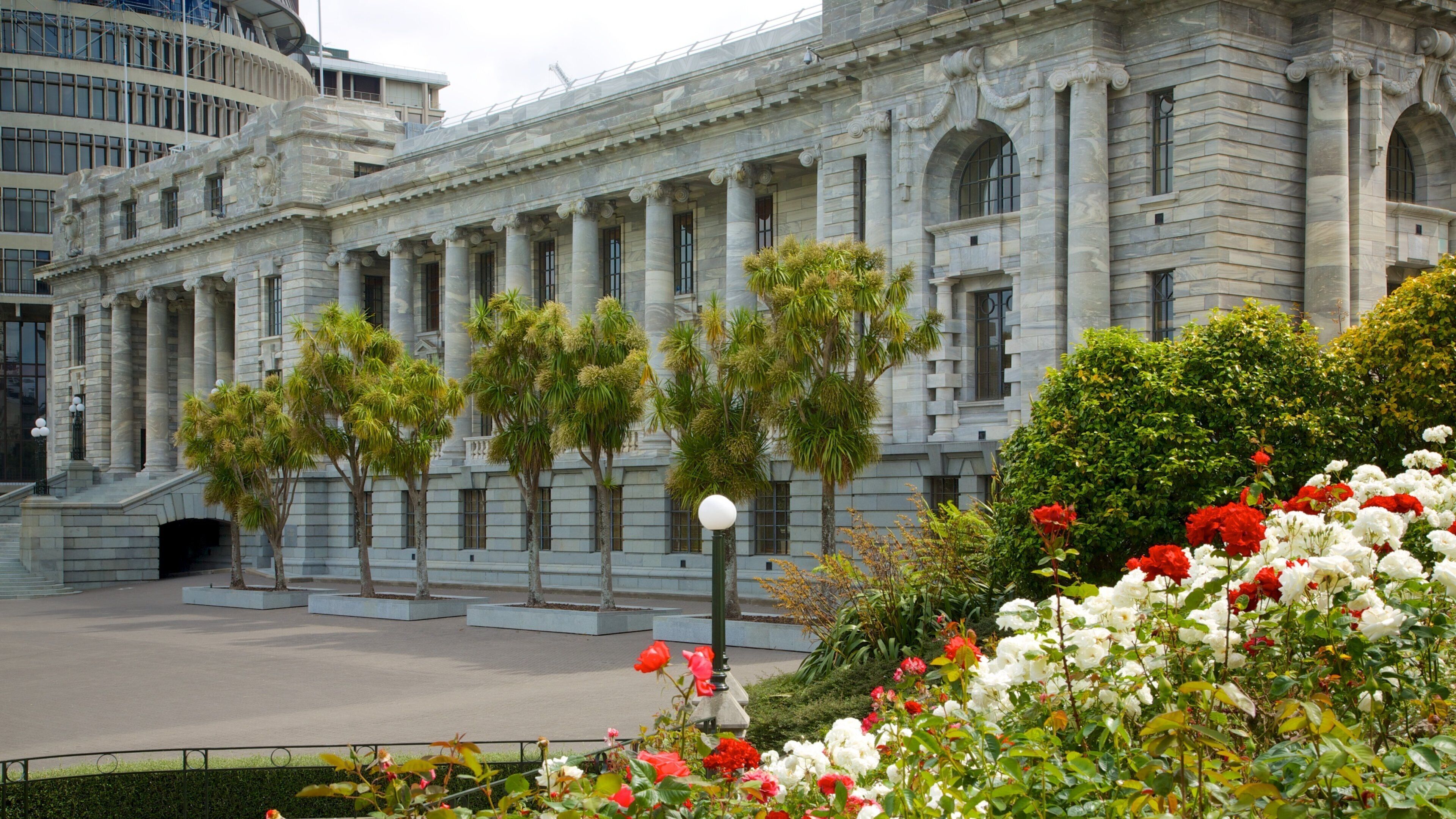 Wellington Parliament featuring heritage architecture, flowers and a square or plaza