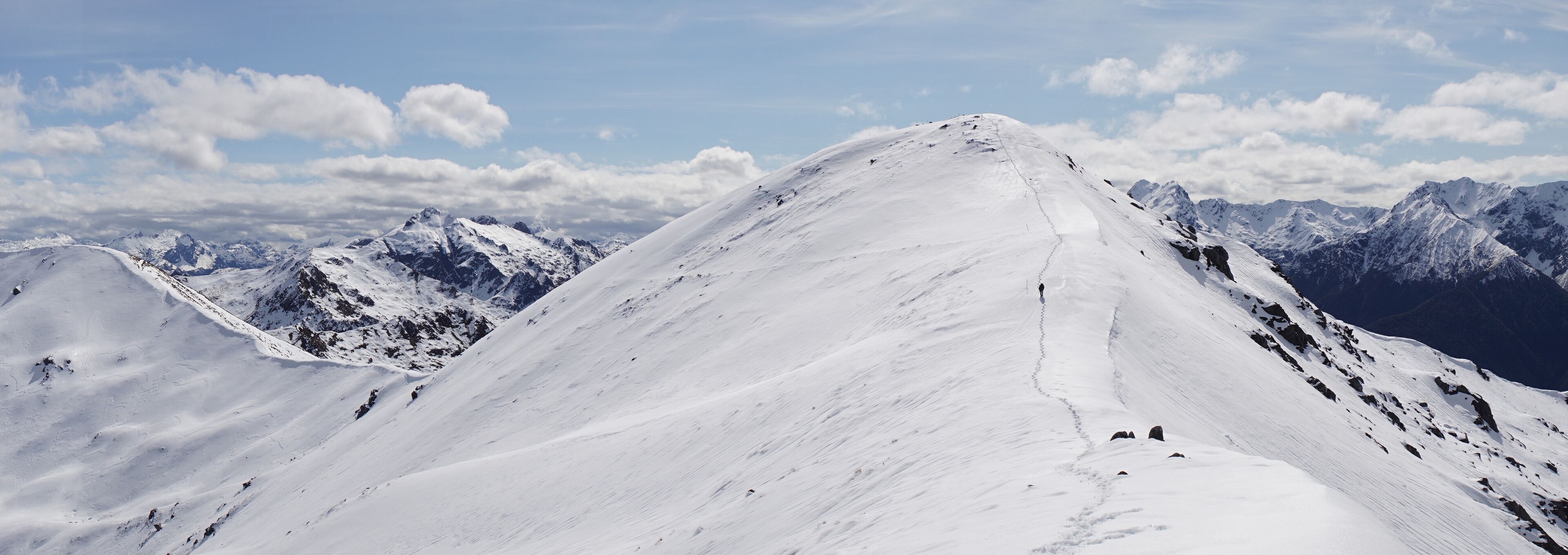 Hiking the Kepler Track during spring in the snow within Fiordland National Park near Te Anau, New Zealand.