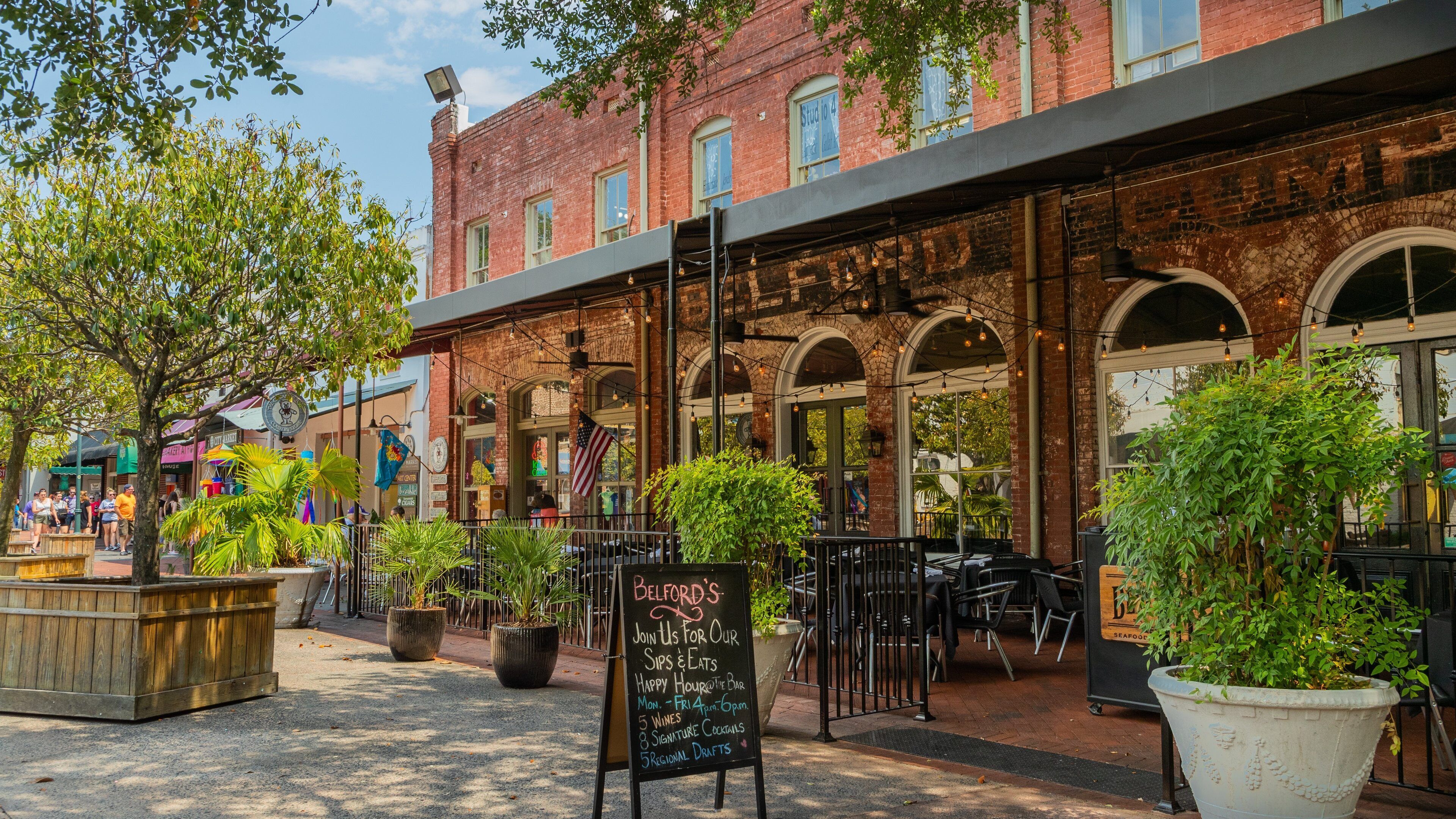 A brick building with outdoor seating and a sign for Belford's.