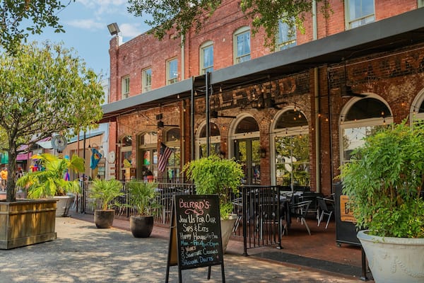 A brick building with outdoor seating and a sign for Belford's.