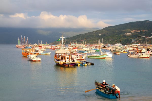 Forno Port showing boating and a bay or harbour as well as a small group of people