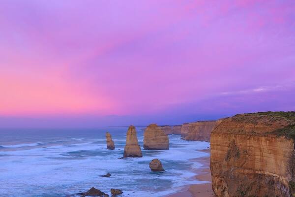 This beautiful sight is only a short drive from Port Campbell by the Great Ocean Road in Victoria. These limestone stacks stand up to 50 metres high and are a spectacular sight to see especially during sunrise or sunsets. Although this formation is called the Twelve Apostles, technically you’re only going to see eight apostles as four have collapsed from erosion since they were first discovered.
I was lucky to have seen the sunrise here every morning for more than a few days and this morning didn't disappoint, the sunrise was spectacular . This is a reverse sunrise shot which means the sun was rising behind me as I took the photo. Although the sunrises at the Twelve Apostles look pretty amazing from the opposite side of the viewing platform any day of the week it's not often you see amazing colours at sunrise looking in this direction across the coastline.