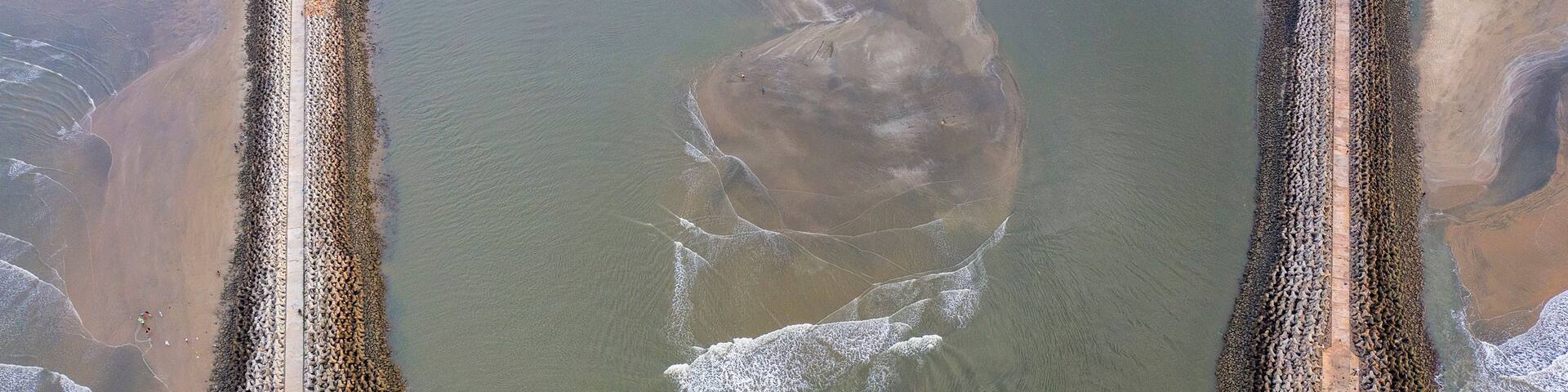 A large body of water with a distinct, curved shoreline.