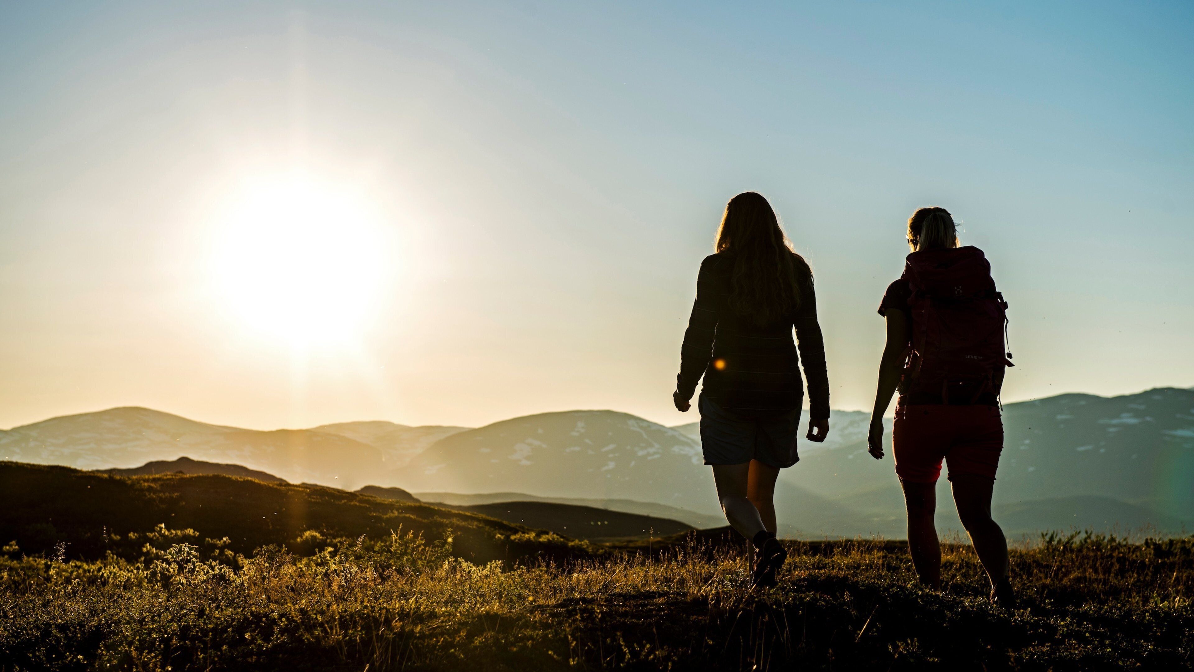 Bjorkliden Fjallby Ski Resort featuring hiking or walking and a sunset as well as a small group of people