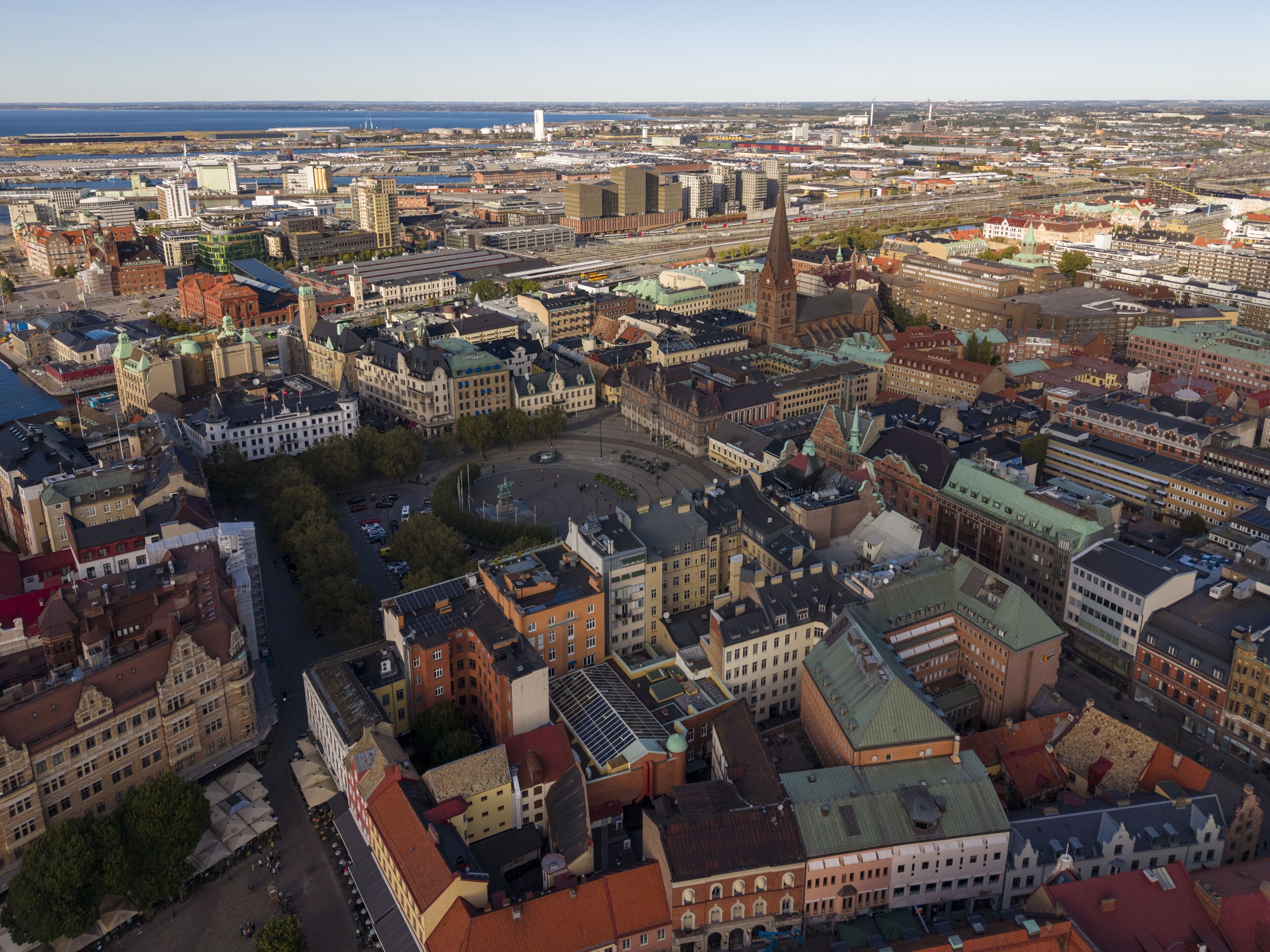 Laaja panoraamanäkymä historialliseen kaupunkiin, jossa on tiheä rakennuskanta, huomattava kirkontorni ja kauempana näkyvä rantaviiva.
