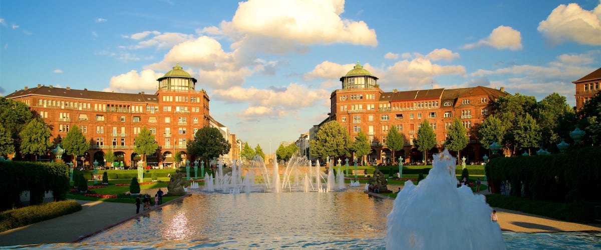 Friedrichsplatz featuring a garden, a fountain and a sunset