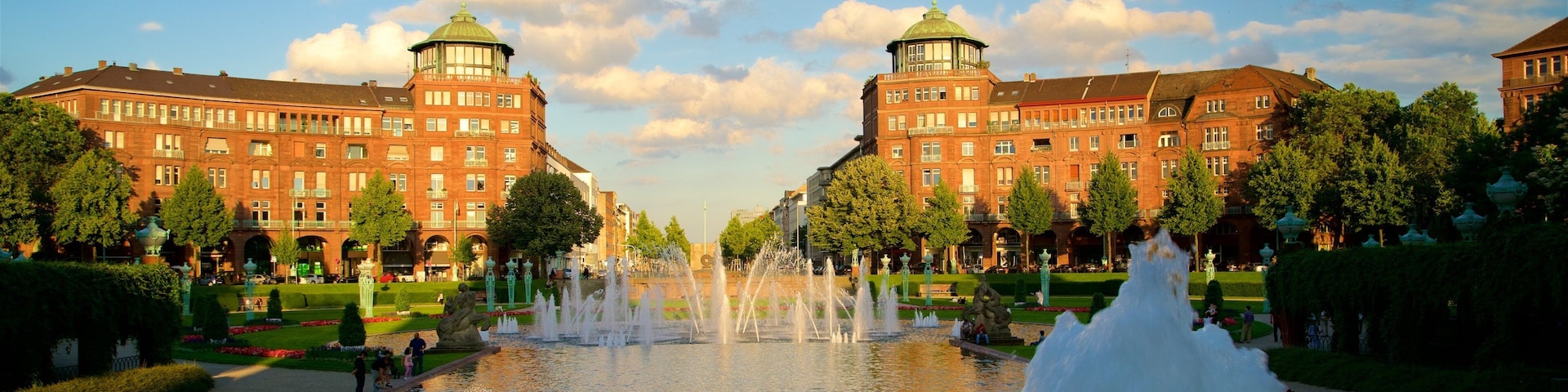 Friedrichsplatz featuring a garden, a fountain and a sunset