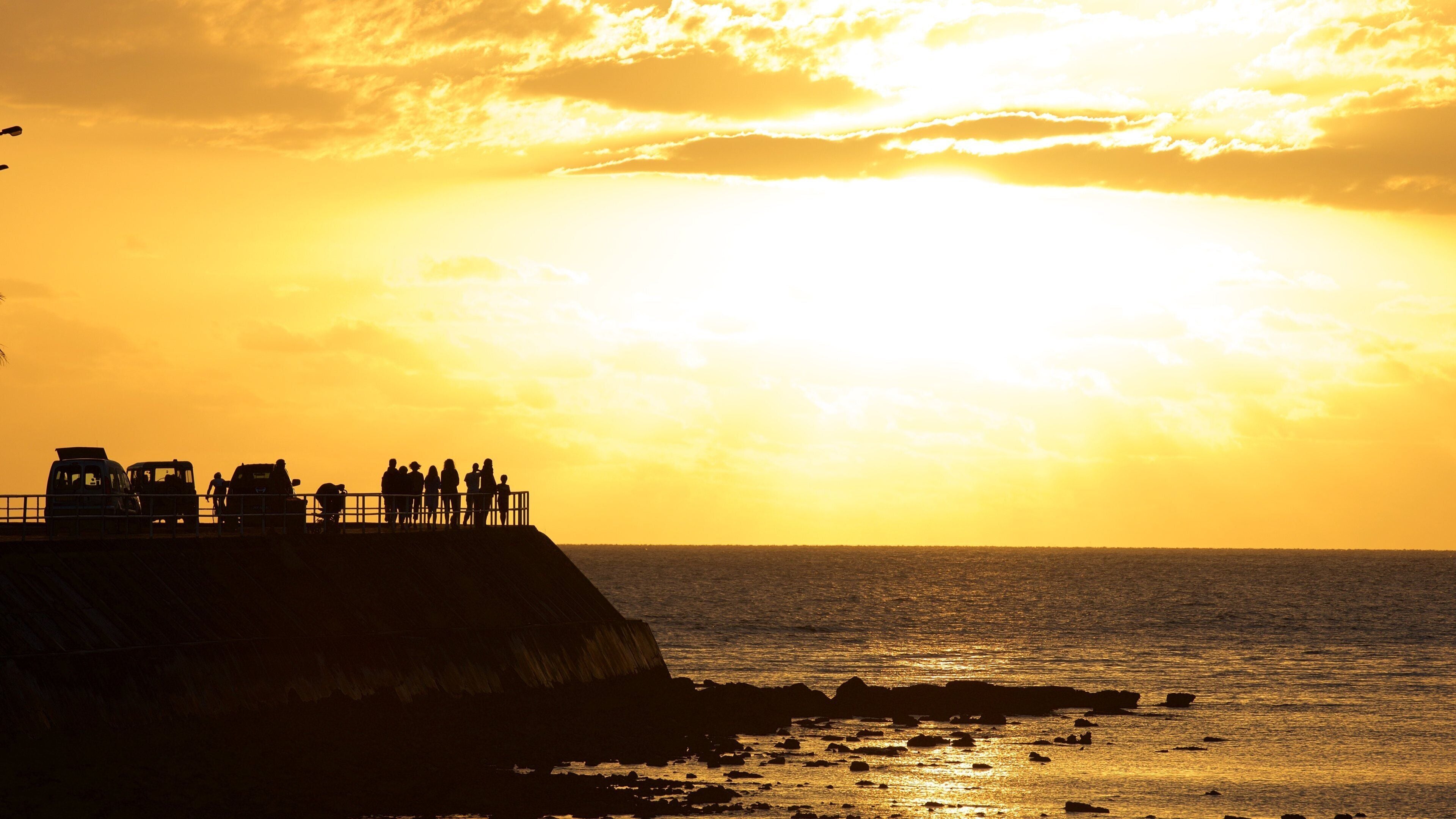 Baie des Citrons featuring rugged coastline, a sunset and views