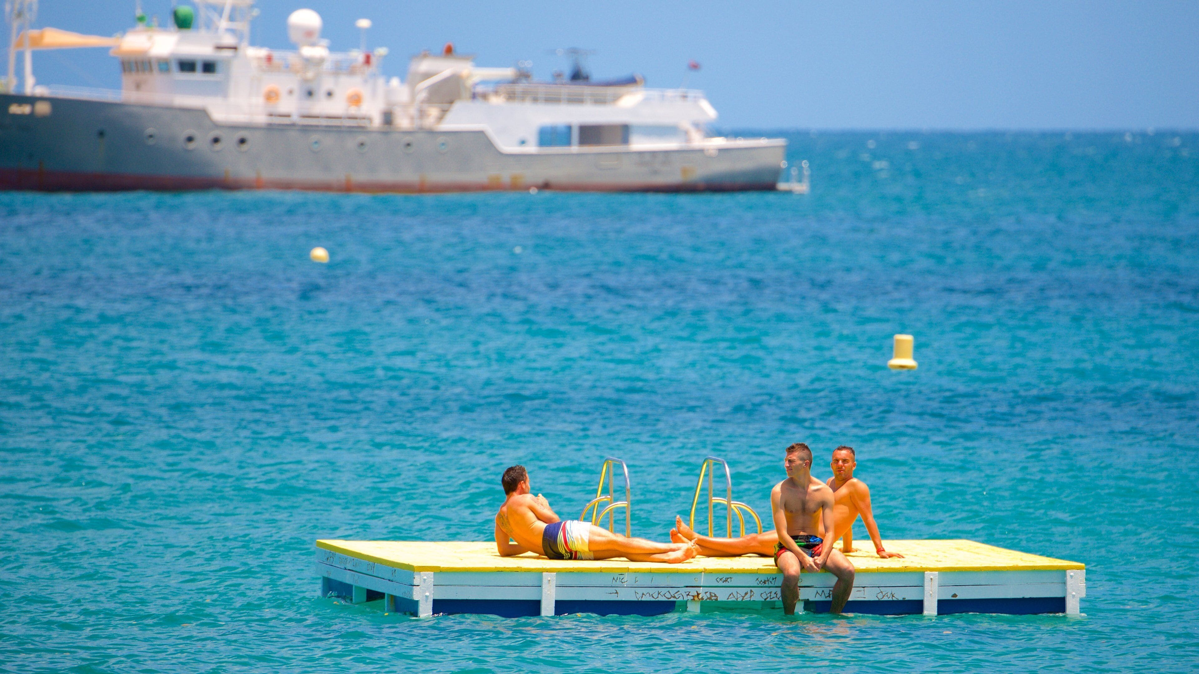 Baie des Citrons featuring swimming as well as a small group of people