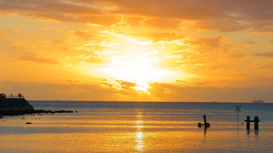 Baie des Citrons featuring a beach and a sunset