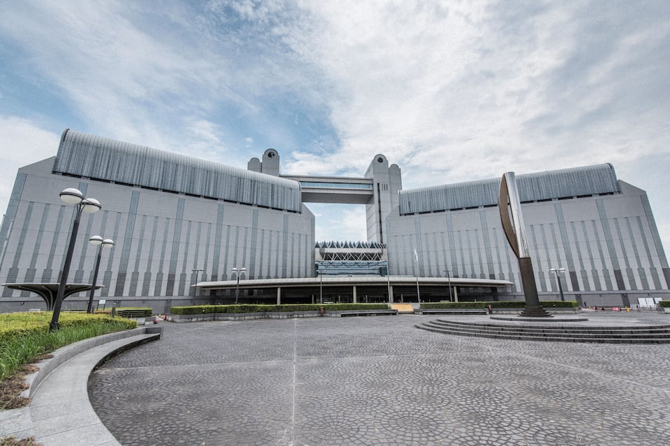 A modern building with a distinctive archway and two symmetrical towers.
