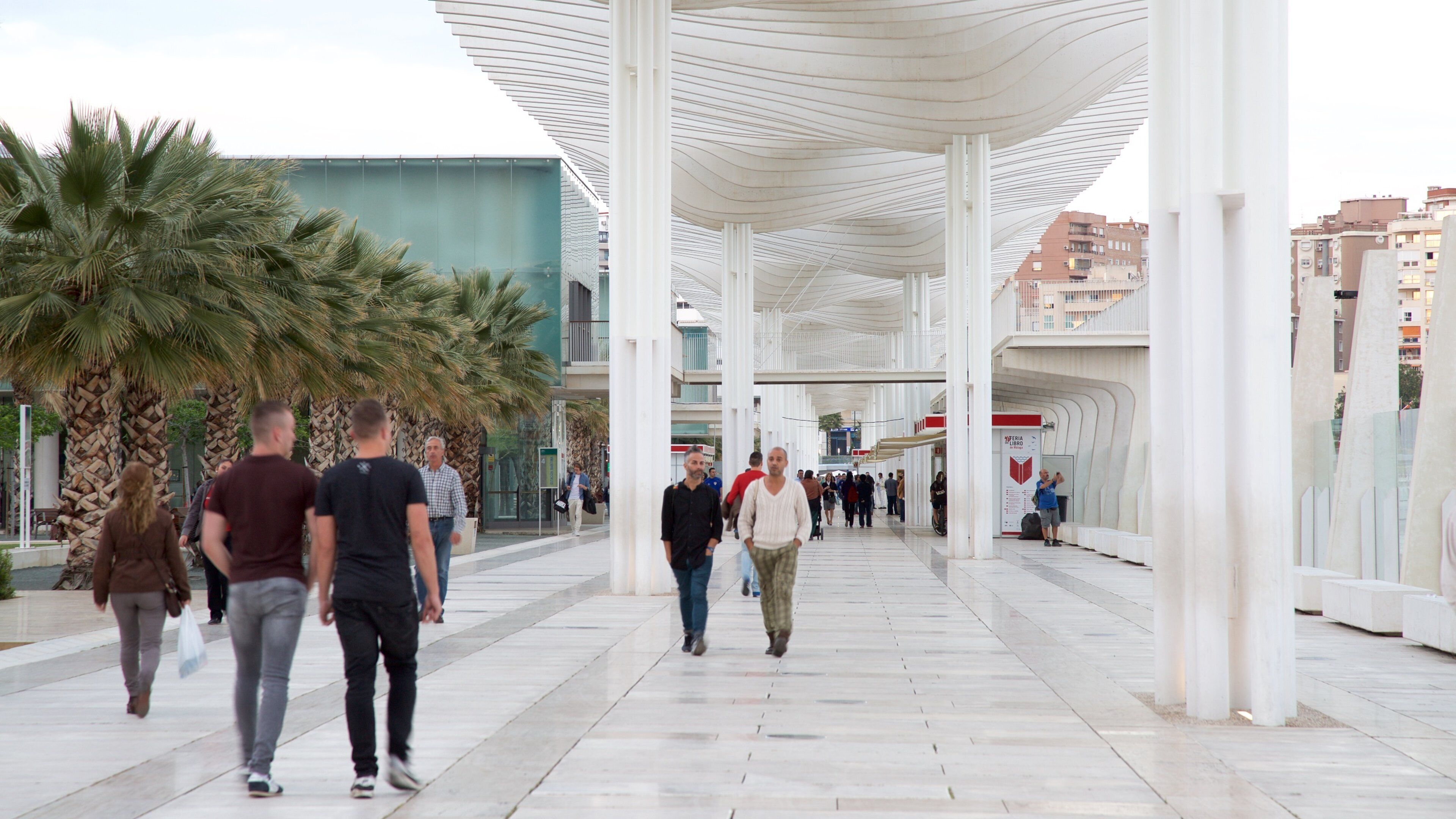 Port of Malaga which includes modern architecture as well as a large group of people