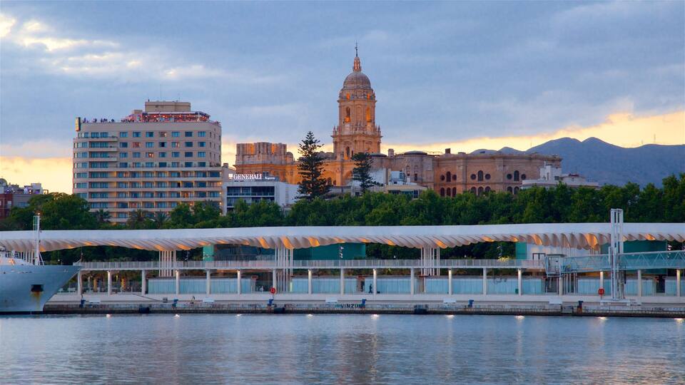 A waterfront with a modern bridge, a historic building with a dome, and a hotel named Generali.
