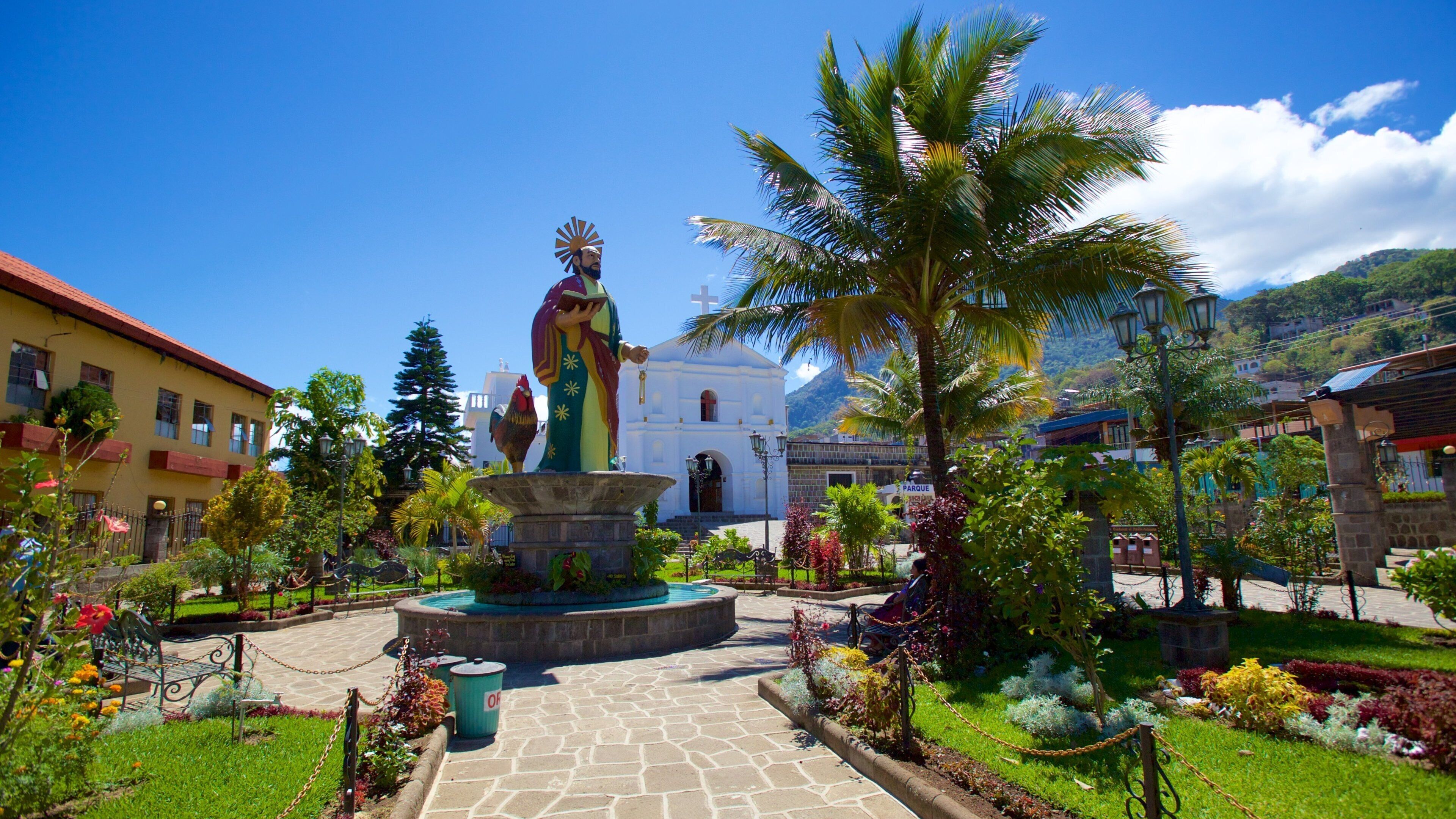 Church of Saint Peter featuring a statue or sculpture and a park