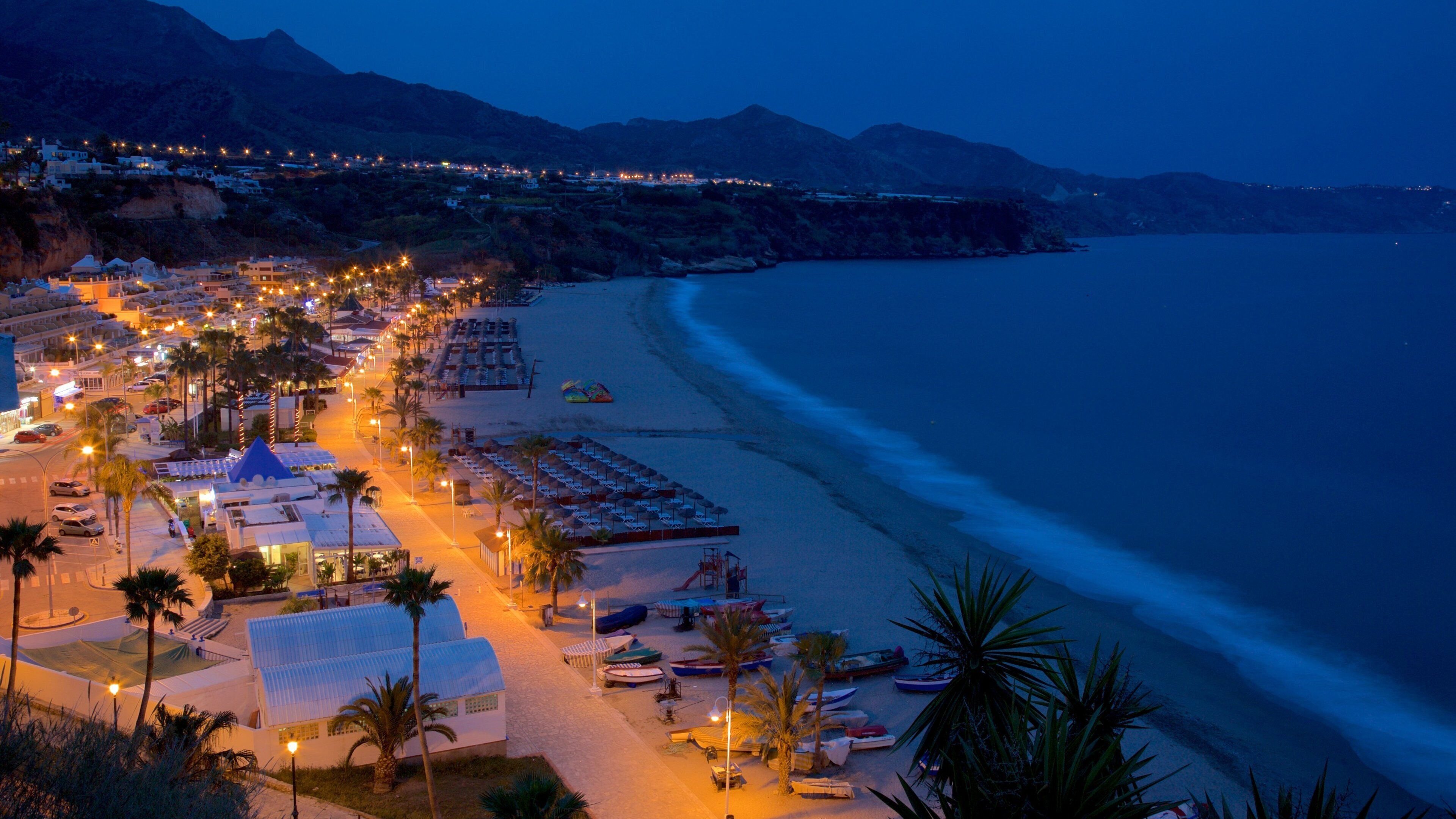 Burriana Beach showing night scenes, a coastal town and landscape views