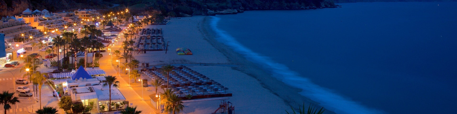 Burriana Beach showing night scenes, a coastal town and landscape views