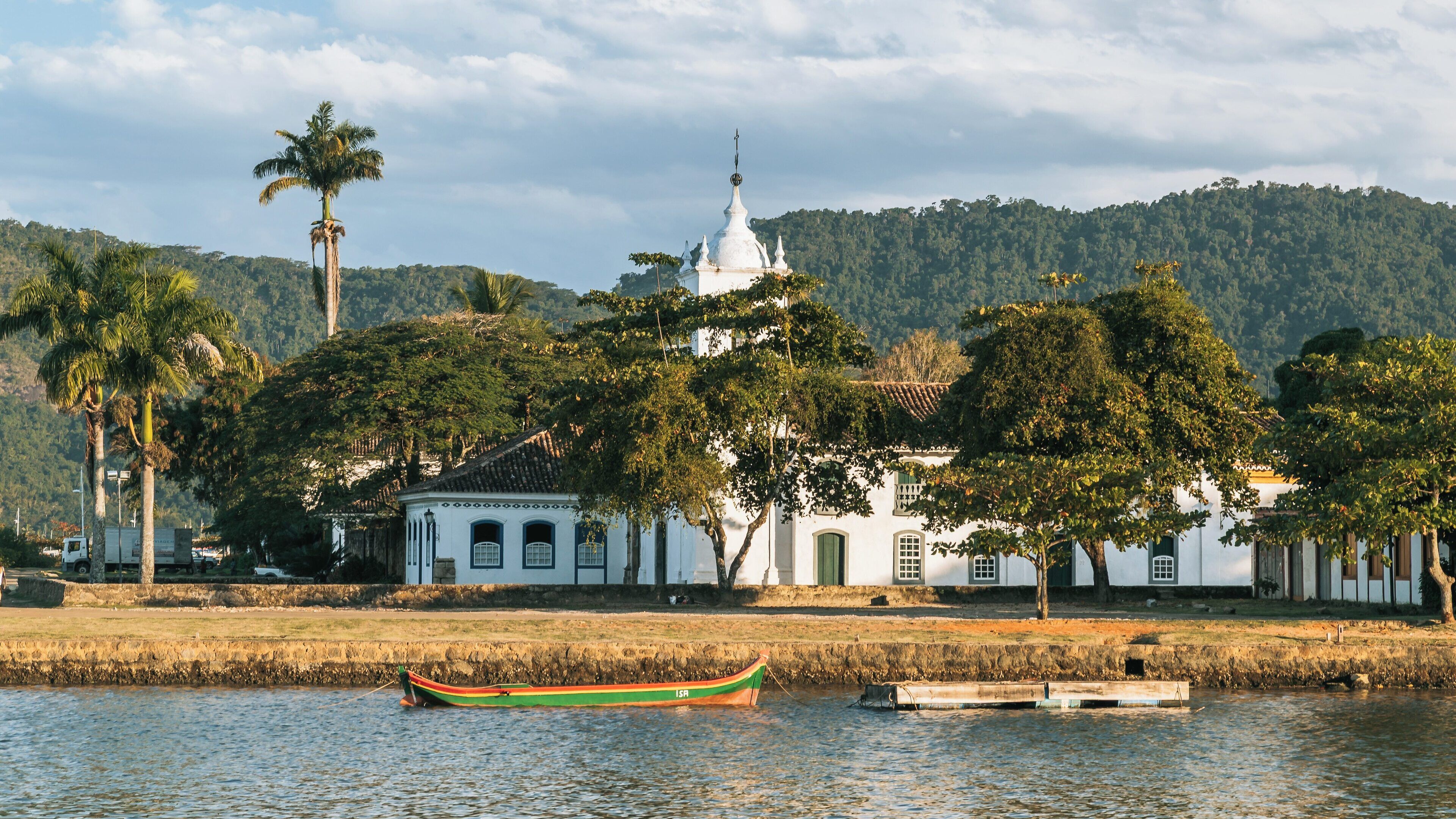 Historic Nossa Senhora das Dores Church showcases colonial architecture in Paraty, Rio de Janeiro State, Brazil alongside lush greenery and tranquil waters