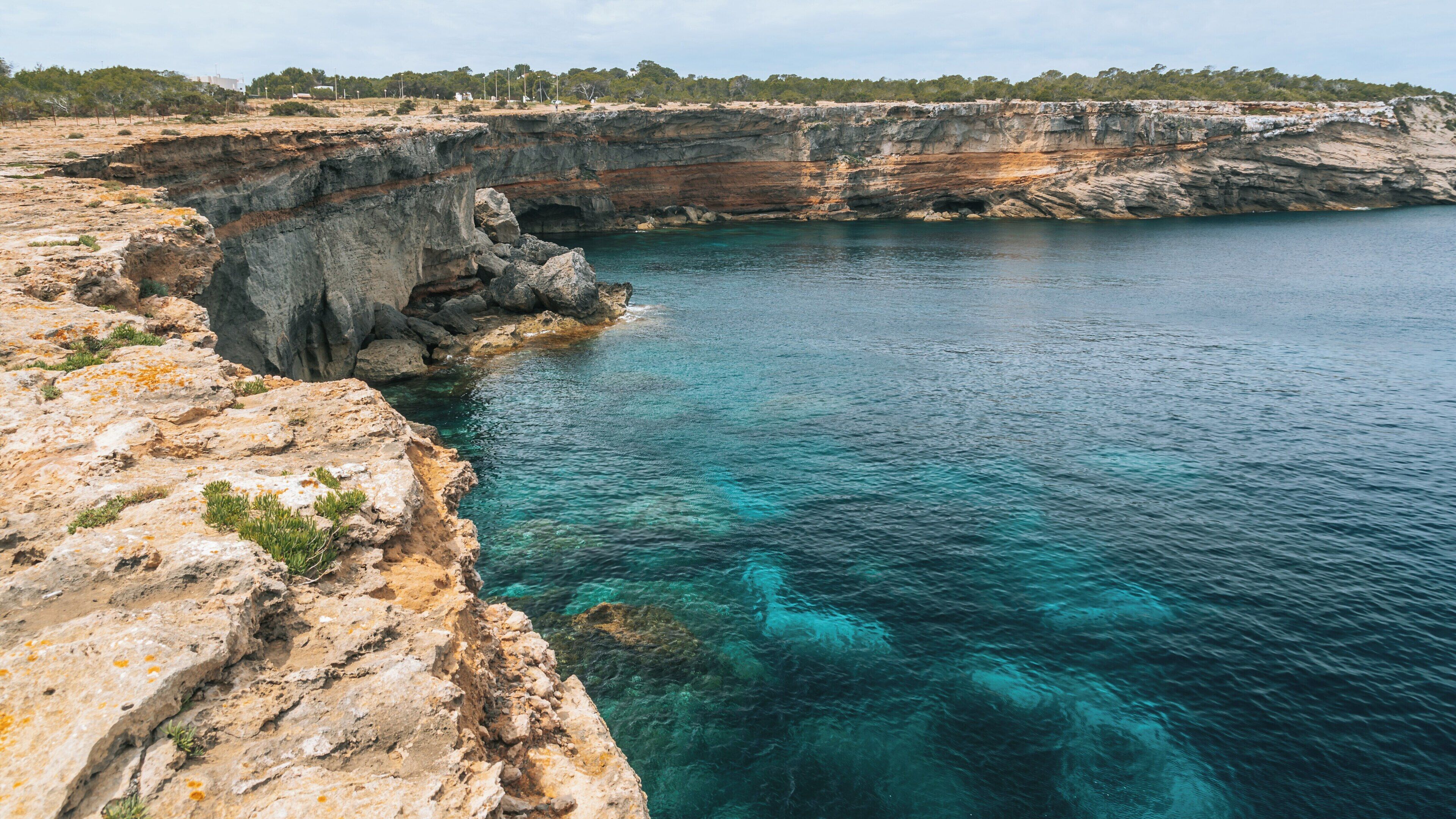Stunning views of Punta Pedrera along the coast of La Savina in Formentera showcasing rocky cliffs and azure waters