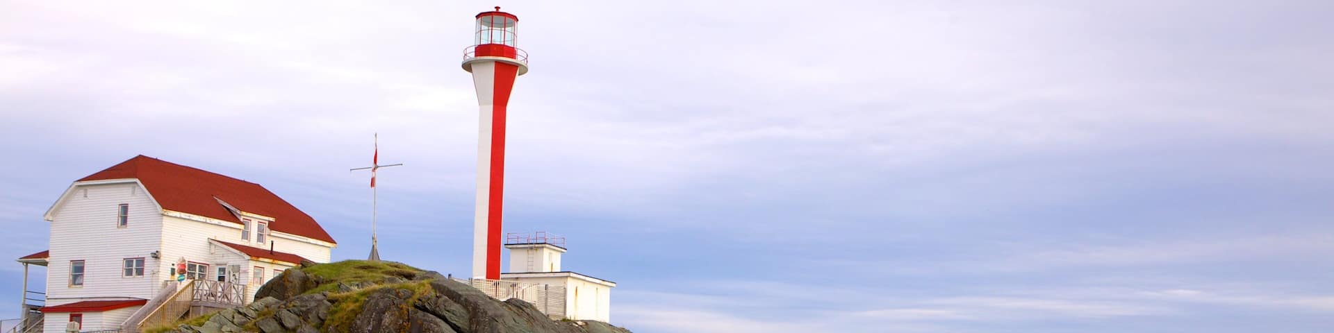 Cape Forchu Lightstation which includes rocky coastline and a lighthouse