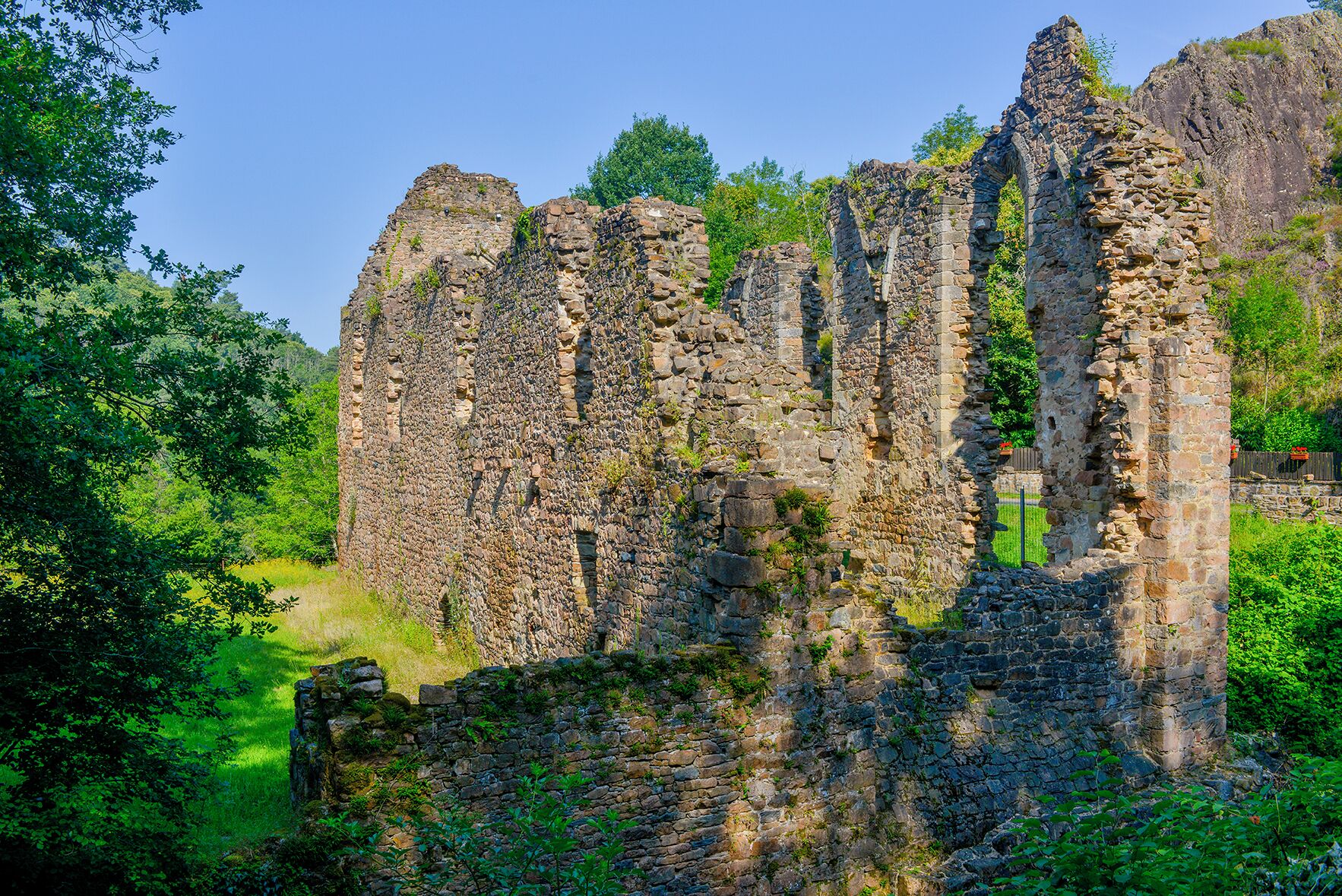 Ancient stone ruins surrounded by lush greenery.