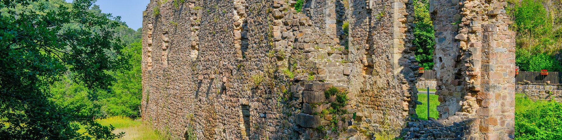 Ancient stone ruins surrounded by lush greenery.
