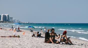 Fort Lauderdale Beach featuring general coastal views and a beach as well as a small group of people