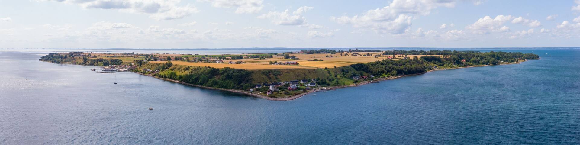 Aerial panorama of the island of Ven in southern Sweden during a warm summer day with Haken lighthouse as the center.