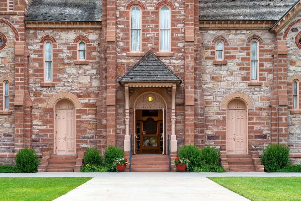 A large stone building with arched windows and a central entrance.